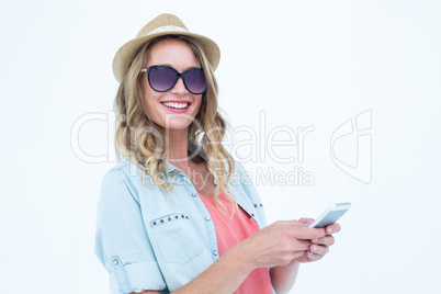 Smiling woman texting with her smartphone