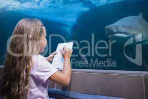 Little girl looking at fish tank