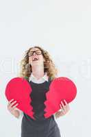 Geeky hipster holding a broken heart card