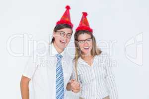 Happy geeky hipster couple with party hat