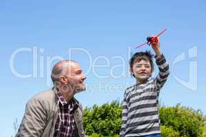 Young boy playing with a toy plane