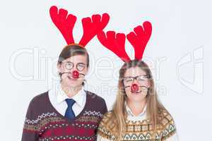 Happy geeky hipster couple with stag headband