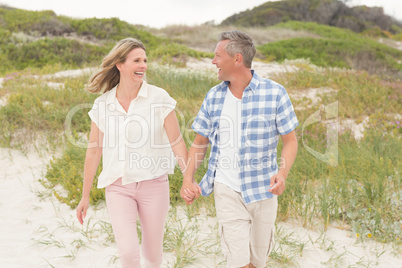 Casual couple walking holding hands