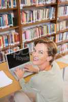 Focus teacher using laptop at library