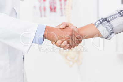 Patient shaking hands with doctor