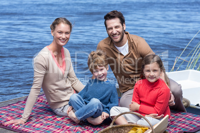 Happy family having picnic at a lake