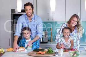 Happy family preparing vegetables together