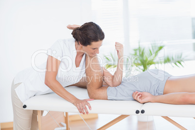 Physiotherapist doing leg massage to her patient