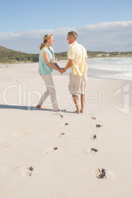 Happy couple walking holding hands