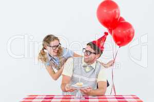 Geeky hipster couple celebrating his birthday