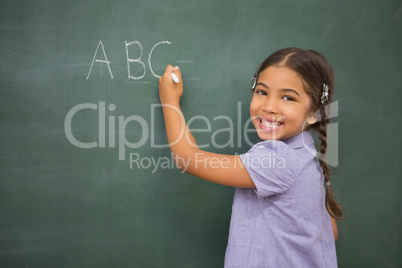 Pupil writing on large blackboard