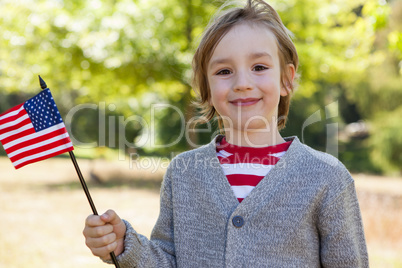 Cute little boy waving american flag