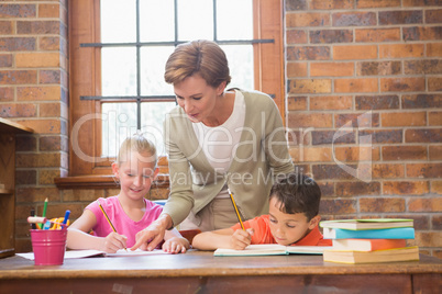 Teacher helping pupils in library