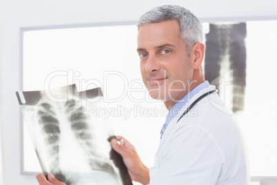 Smiling doctor looking at X-Rays