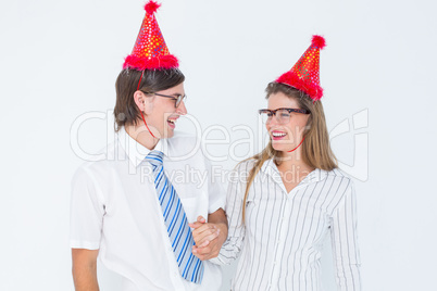 Happy geeky hipster couple with party hat