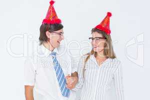 Happy geeky hipster couple with party hat
