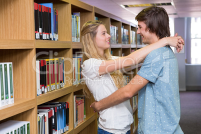 Cute couple embracing each other in the library