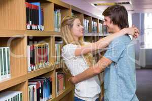 Cute couple embracing each other in the library