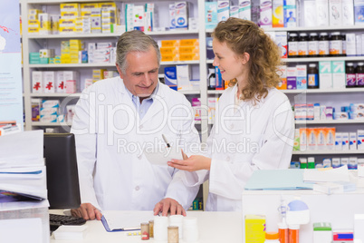 Team of pharmacists looking at prescription