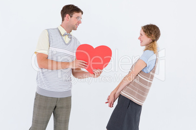 Geeky hipster giving heart card to his girlfriend