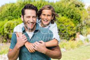 Father and son smiling at camera