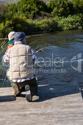 Happy man fishing with his son