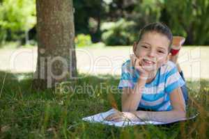 Cute little girl reading in park