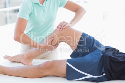 Doctor examining man leg