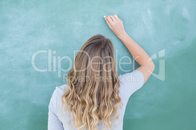 Teacher writing on blackboard