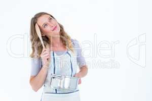 Thoughtful woman holding saucepan