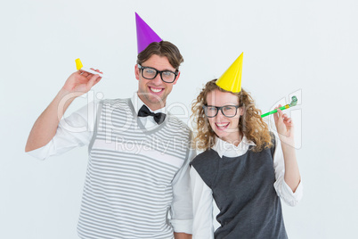 Geeky couple with party hat and party horn