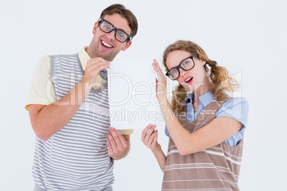 Geeky hipster couple holding poster