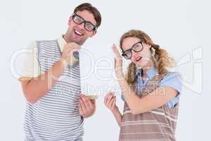 Geeky hipster couple holding poster