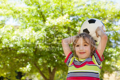 Happy little boy holding football