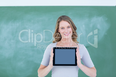Smiling teacher holding tablet pc