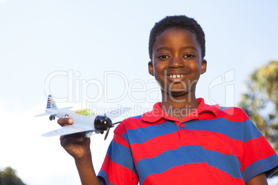 Little boy playing with toy airplane