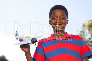 Little boy playing with toy airplane