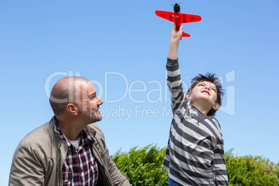 Young boy playing with a toy plane
