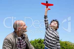 Young boy playing with a toy plane