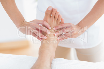 Physiotherapist doing foot massage