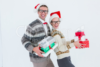 Geeky hipster couple holding presents