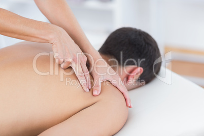 Physiotherapist doing shoulder massage to her patient