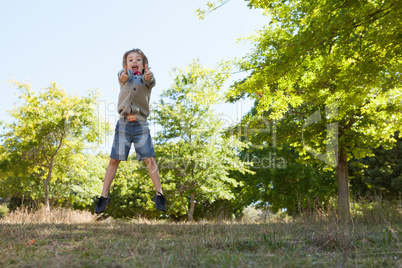 Cute little boy jumping in park