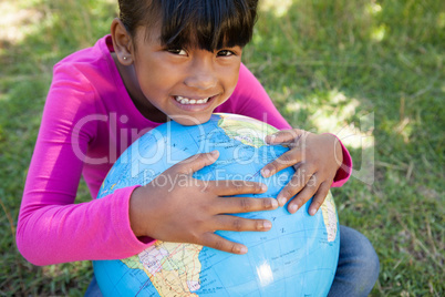 Cute little girl holding globe