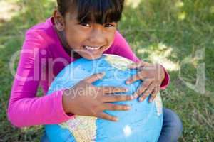 Cute little girl holding globe
