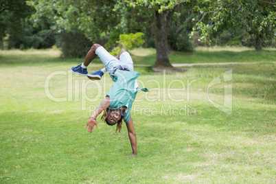 Hipster doing back flip in the park