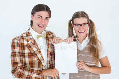 Geeky hipsters holding a poster