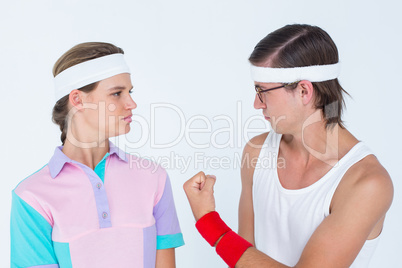 Geeky hipster showing fist to his girlfriend