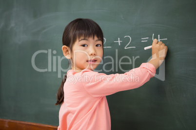 Pupil writing numbers on a blackboard