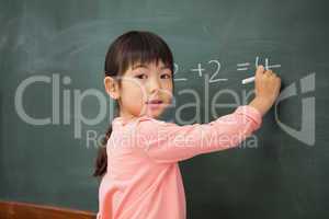 Pupil writing numbers on a blackboard